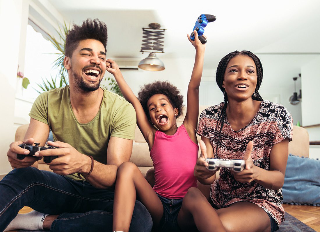 About Our Agency - Fun Family Playing Video Games Together at Home